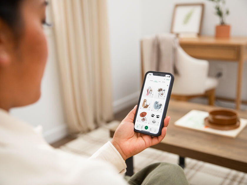 Hand adding citrus garnish to personalised holiday tumbler glass